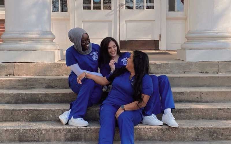 Nursing students hanging out in scrubs.