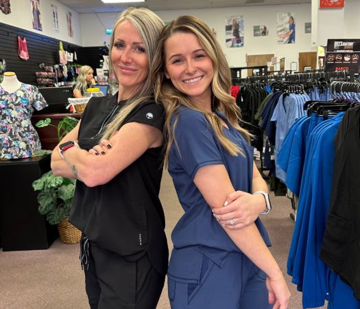 Two women wearing scrubs at Scrubs by Identity Factor.