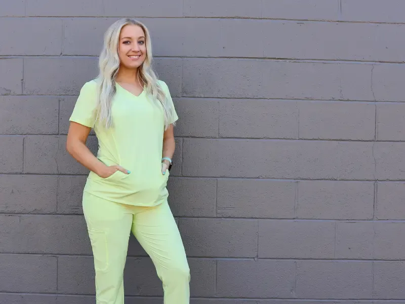 Lime green GRN8 scrubs on a woman.